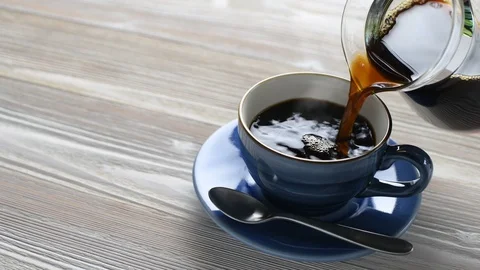 Pouring coffee into a cup Stock Footage 128676388