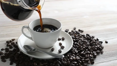 Pouring coffee into a cup Видео 128688376