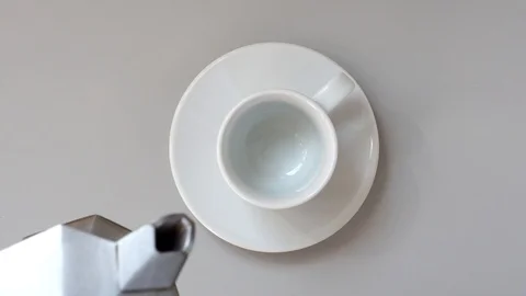 Pouring Coffee In a Cup. Gray table. Top view Vidéo 88889574