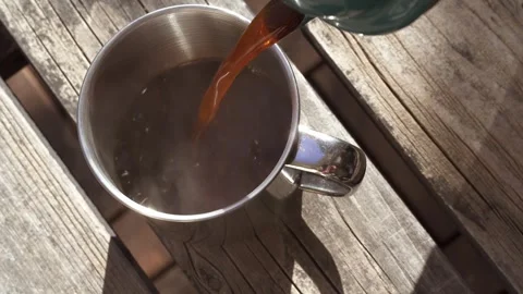 Pouring coffee into a cup outdoors Stock Footage 273774226