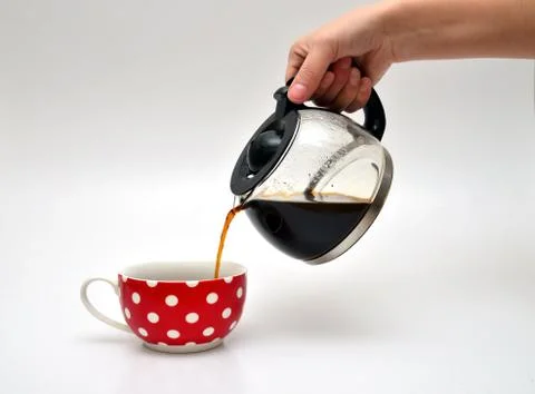 Pouring coffee in a cup Stock Photos