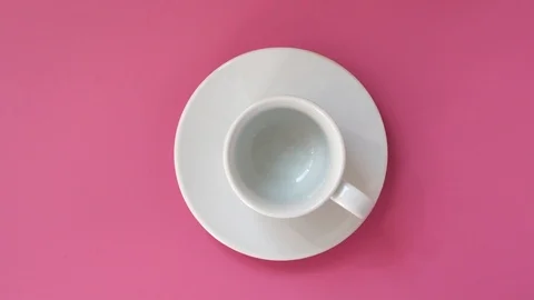 Pouring Coffee In a Cup. Pink table. Top view Stock-Footage 88889579