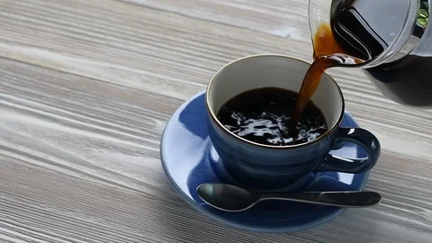 Pouring coffee into a cup - slow motion . Stock Footage 128626033