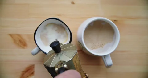 Pouring coffee into cups creates delightful morning routine Stock Footage 299903019