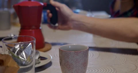 Pouring coffee during a digital board game. Stock Footage 326873804