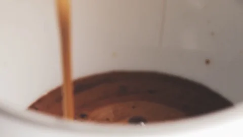 Pouring coffee from espresso machine to cup from above in slow motion Stock Footage 85182598