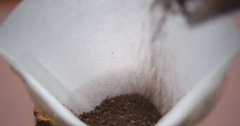 Pouring Coffee Grounds into a Chemex Filter Stock Footage 100084262