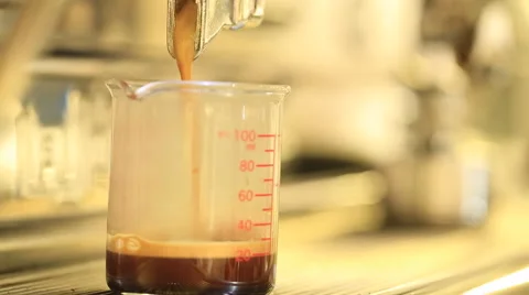 Pouring coffee, making espresso in measuring glass transparent Stock Footage 51935532