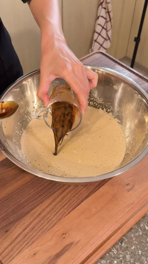 Pouring Coffee Mixture into Cake Batter, Adding Nescafe Flavor in Baking Process Stock Footage 331038955