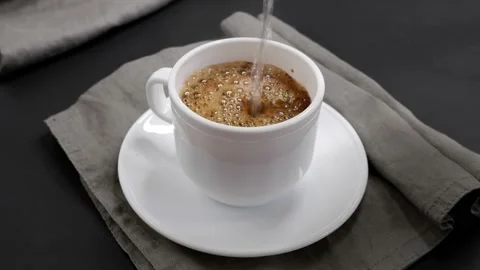 Pouring coffee into a mug. Coffee in a white mug. Delicious aromatic drink. Stock Footage 154458741