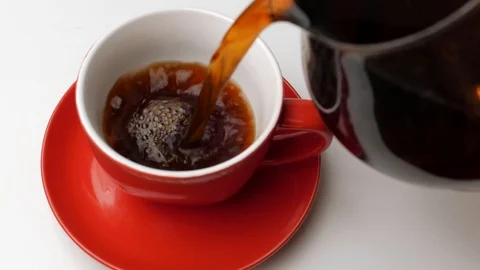 Pouring coffee in a red cup Stock Footage 106396794