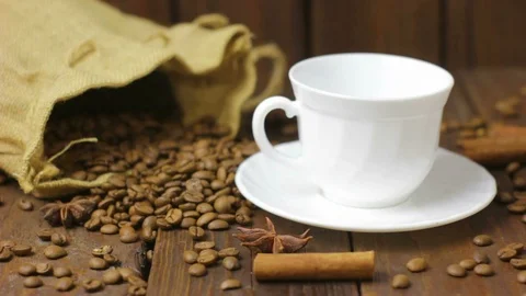 Pouring Coffee on Rustic Wooden Background with Burlap Bag Video stock 105056906
