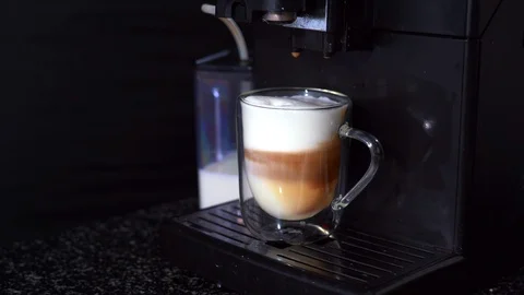 Pouring coffee stream from automatic coffee latte machine in cup. Stock Footage 124900004