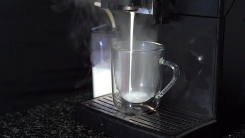 Pouring coffee stream from automatic coffee latte machine in cup. Stock Footage 124901312