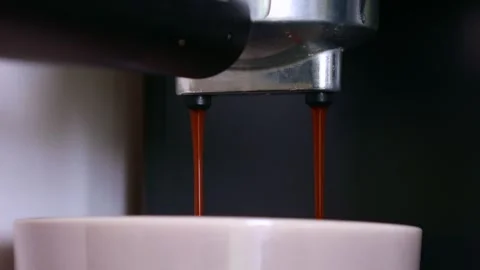 Pouring coffee stream from automatic machine into cup close up Stock Footage 273572696