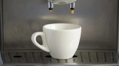 Pouring coffee stream from machine in cup. Home making hot Espresso. Stock Footage 142465561