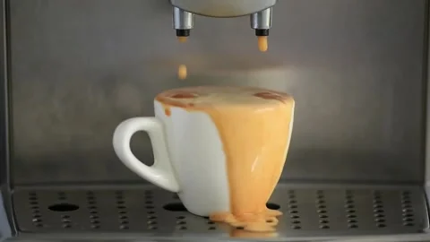 Pouring coffee stream from machine in cup. Coffee is pouring out of a cup. Stock Footage 142502971
