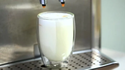 Pouring coffee stream from machine in cup. Home making hot Latte. Stock Footage 142642557