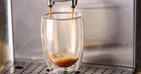 Pouring coffee stream from machine into a cup. Stock Footage 170017689
