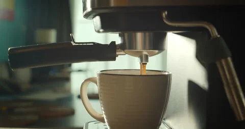 Pouring coffee stream from machine in cup. Home making hot Espresso. Using Video stock 171021667