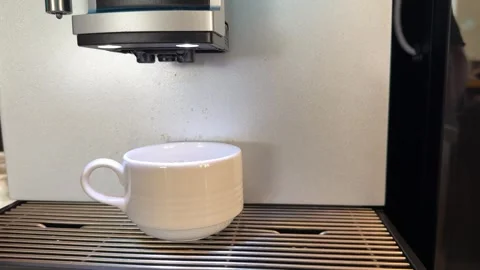 Pouring coffee stream from machine in cup. Home making hot mochaccino. Close-up Видео 275750961