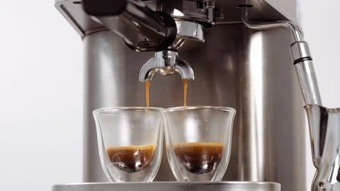 Pouring coffee stream from professional machine in cups. Making double espresso. Stock Footage 112678923