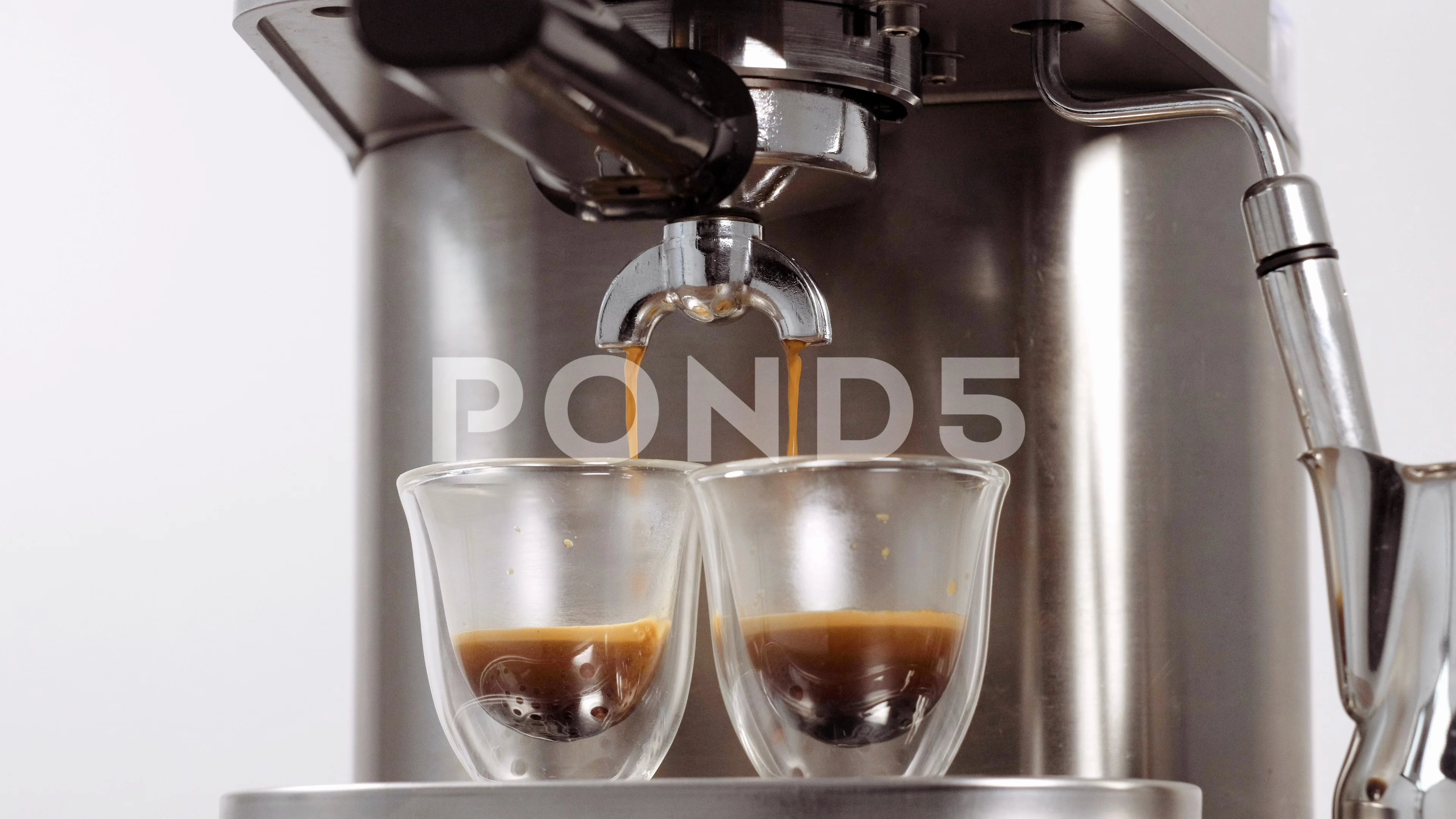 Pouring coffee stream from professional machine in cup. Barista