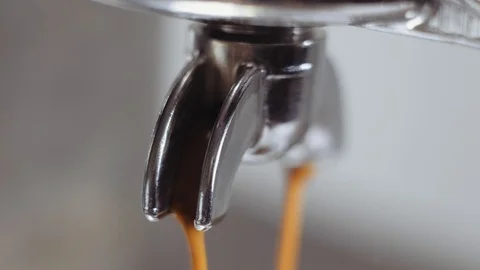 Pouring coffee stream from professional machine in cup. Making espresso. Video stock 112681937