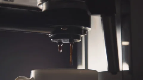 Pouring coffee stream from professional machine in cup Flowing fresh ground coff Stock Footage 126406484