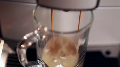 Pouring coffee stream from professional machine in cup. Barista making double Stock Footage 128692631