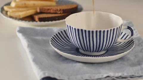 Pouring coffee into a striped cup Video stock 77888593