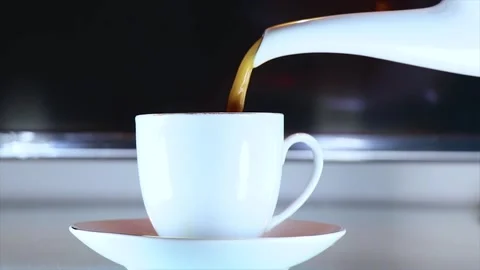 Pouring Coffee From The Teapot Into a Cup. Video stock 170660632