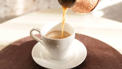 Pouring coffee into a white cup. 스톡 동영상 72265113