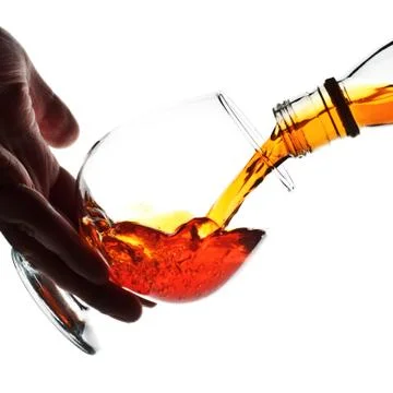 Pouring cognac Stock Photos