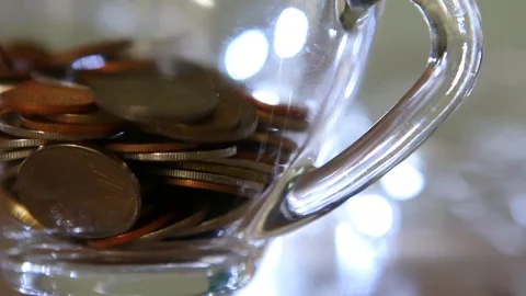 Pouring coins to a cup of tea, in studio Chiangmai Thailand Stock Footage 112172187