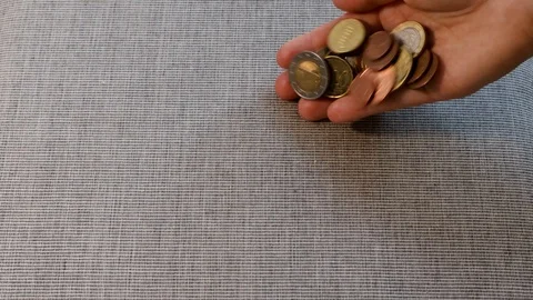 Pouring coins Stock Footage 103042890