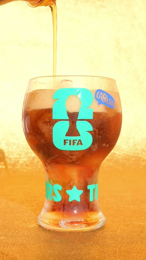 Pouring cola to a cup of THE MONSTERS x FIFA SERIES-Glass Cup Stock Footage 337893131