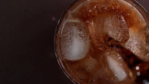 Pouring cola drink with ice cubes close-up. Stock Footage 274096404