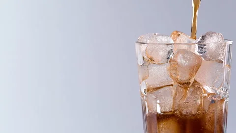 Pouring cola drink with ice cubes close-up. Stock Footage 274096684