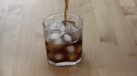 Pouring Cola In Full Of Ice In Glass Video stock 66465272