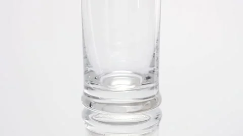 Pouring cola into a glass and adding ice cubes Stock Footage 8573129