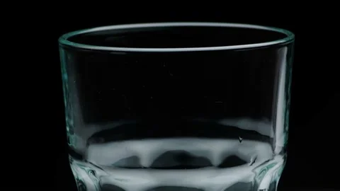 Pouring cola in a glass on a dark surface. Macro shot 動画素材 141810060