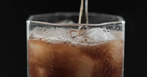 Pouring cola into a glass with ice Stock Footage 144831430