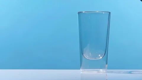 Pouring cola into a glass on a table in a clean, studio environment. Shot in slo Video stock 74825798
