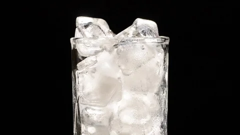 Pouring Cola with ice cubes close-up on black background Video stock 115132441