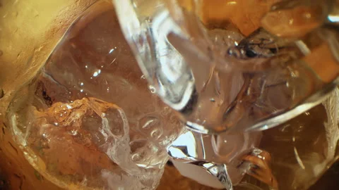 Pouring Cola with ice cubes close-up. Stock Footage 143486533