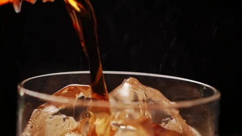 Pouring Cola with ice cubes close up rotation black background Stock Footage 171018945