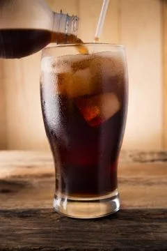 Pouring of cola Stock Photos