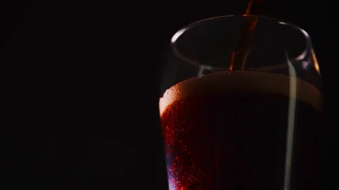 Pouring Cola slow motion close up. Cola with bubbles in a glass. Coke Soda Stock-Footage 119123018