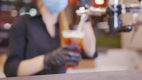 Pouring cold beer into glass. Bartender pouring craft beer in the bar. The hand Stock Footage 145437606
